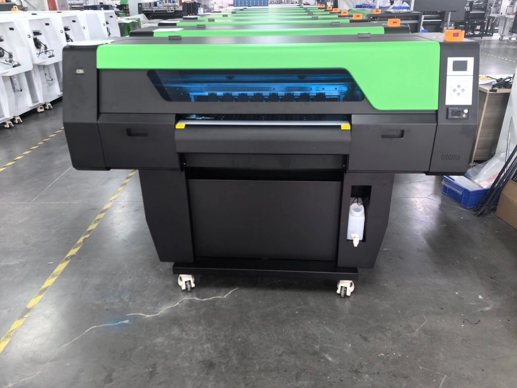 Finished green and black printer equipment on a production floor