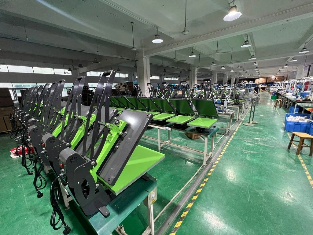 Rows of green and black heat presses on a production floor